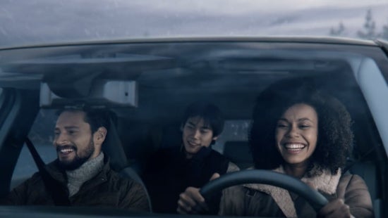 Three passengers riding in a vehicle and smiling | Bennington Nissan in Bennington VT
